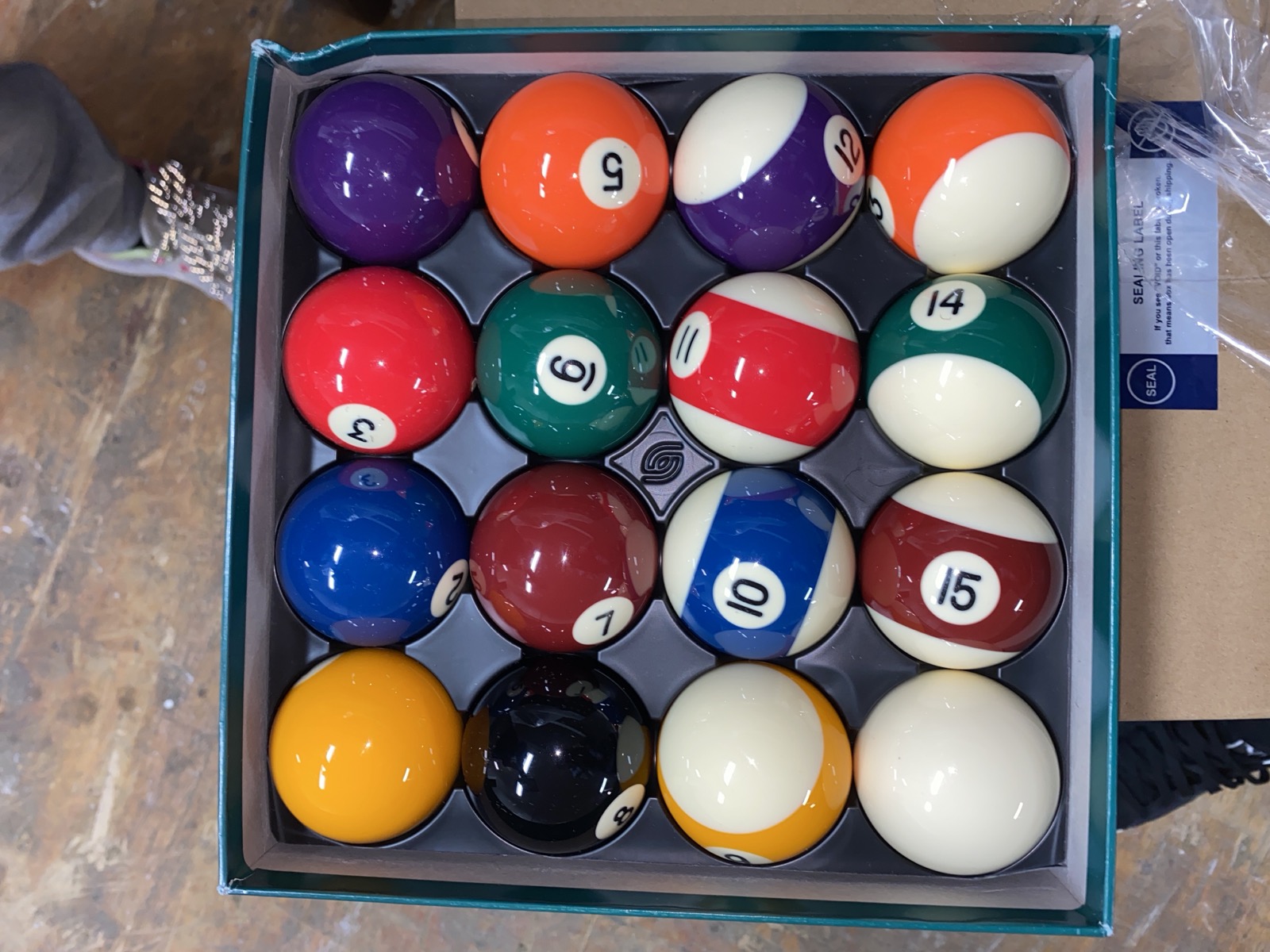 Fresh set of pool balls in a box