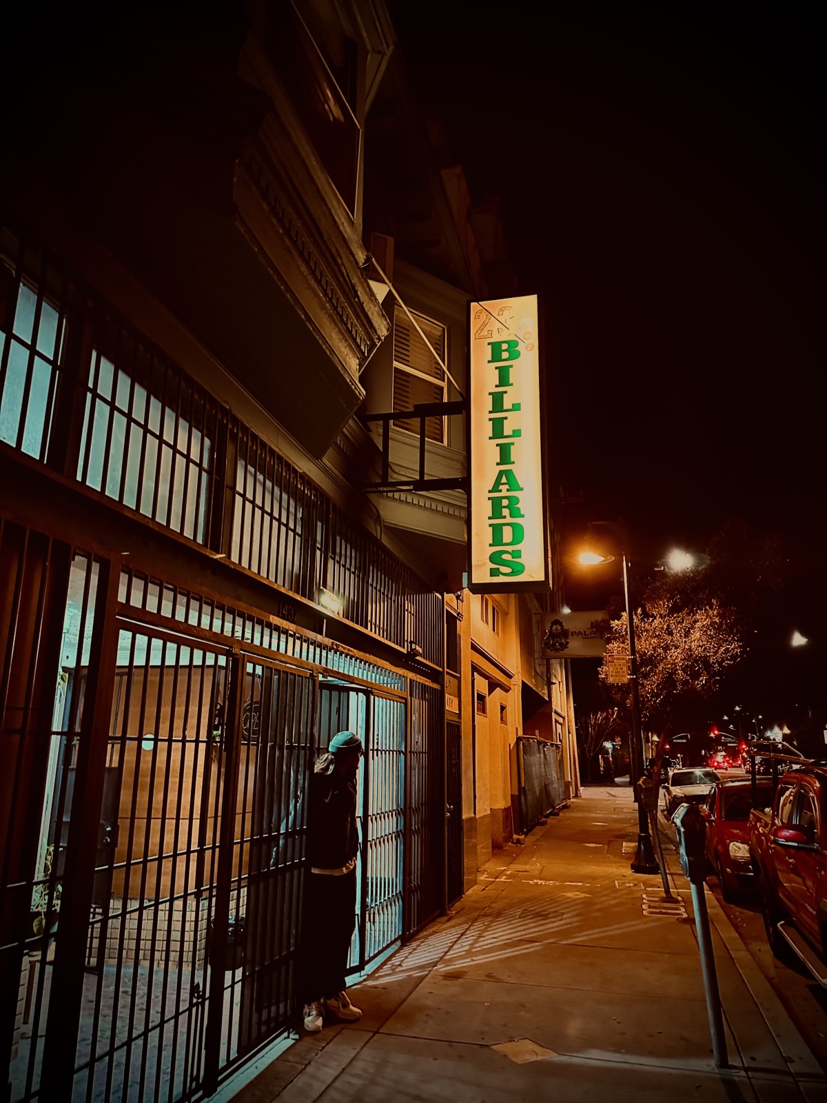 The 23rd Billiards neon sign glowing on the Oakland street at night
