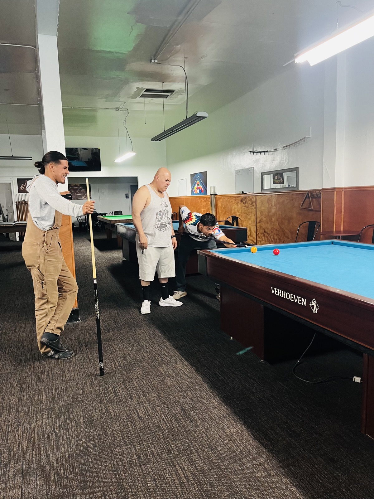 The three owners of 23rd Billiards — Julio Cervantes Lopez and his sons Oscar and Julio — at a carambola table