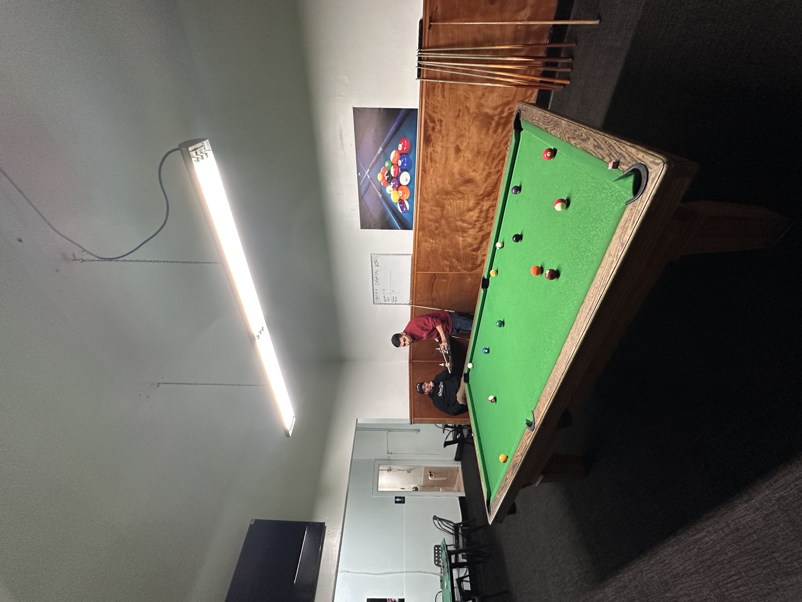 Players mid-game on a green Verhoeven table