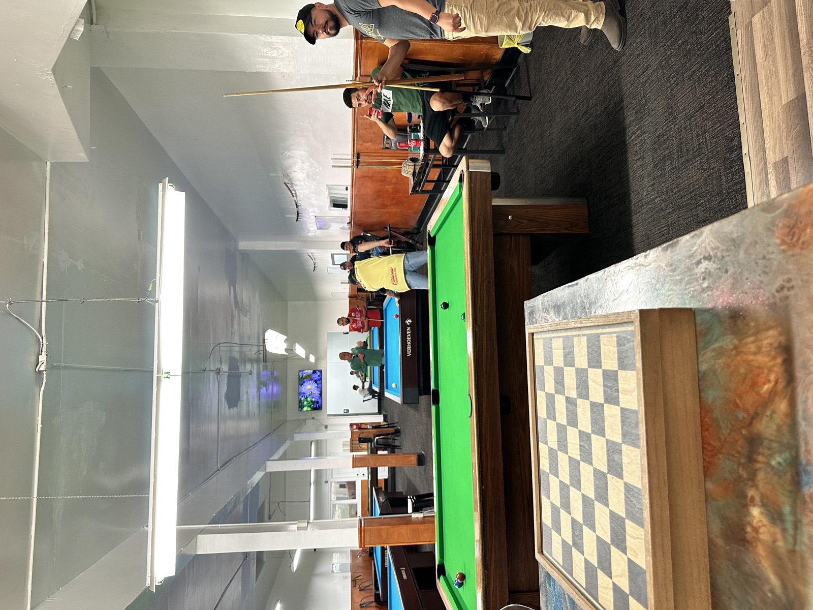 People playing and socializing at 23rd Billiards